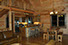 A view of the fully equipped kitchen, half log bar and dining area.